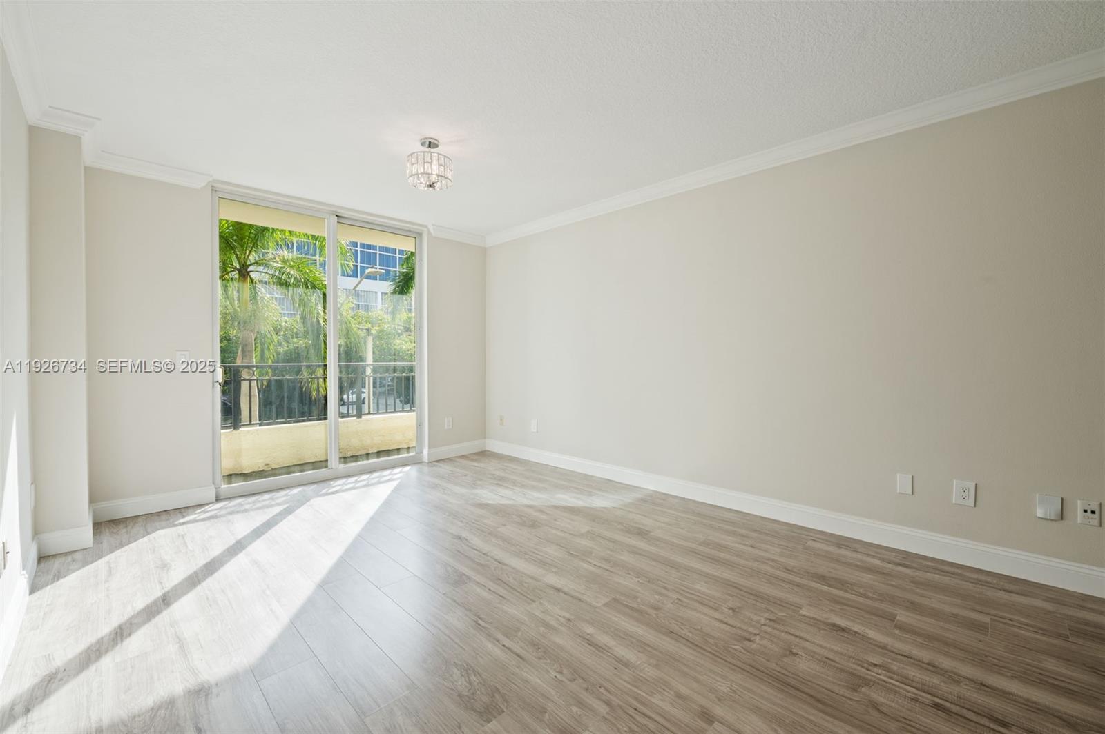 600 South Dixie Highway, Unit 237 West Palm Beach, FL 33401 - Photo 43 of 46 a view of an empty room with wooden floor and a window