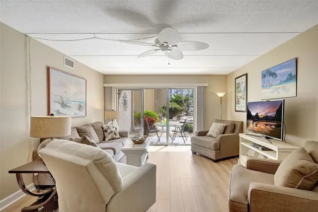 a dining room with stainless steel appliances a dining table and chairs