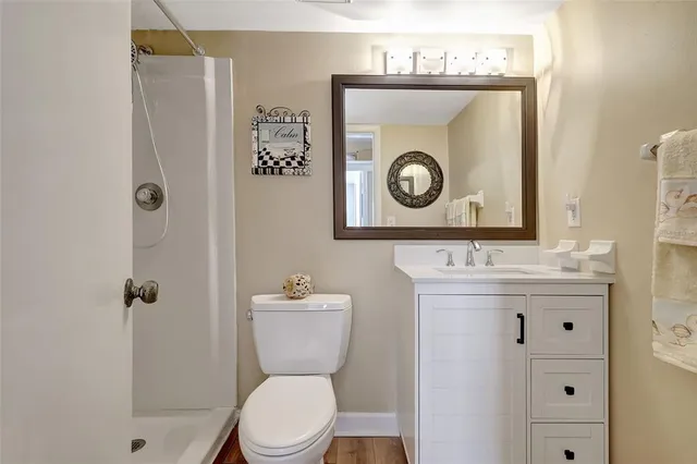 a bathroom with a double vanity sink a mirror and a shower