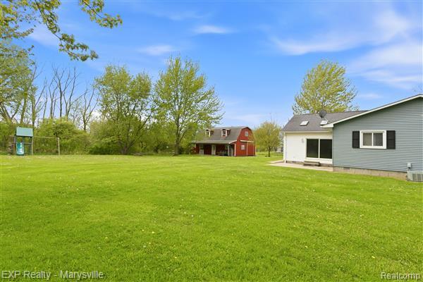 12265 Hough Road Memphis, MI 48041 - Photo 33 of 41 View of green lawn featuring an outbuilding