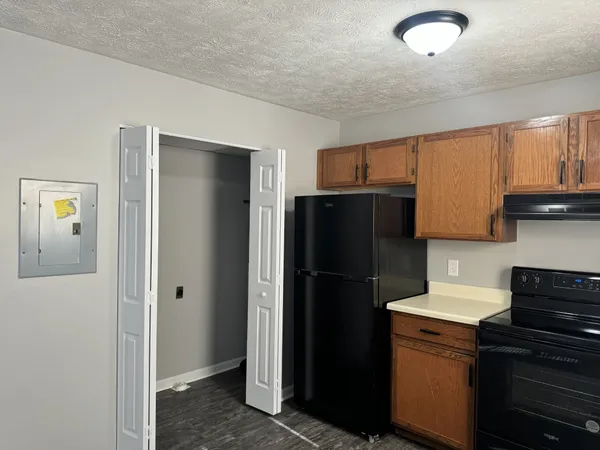 a kitchen with a refrigerator and a sink