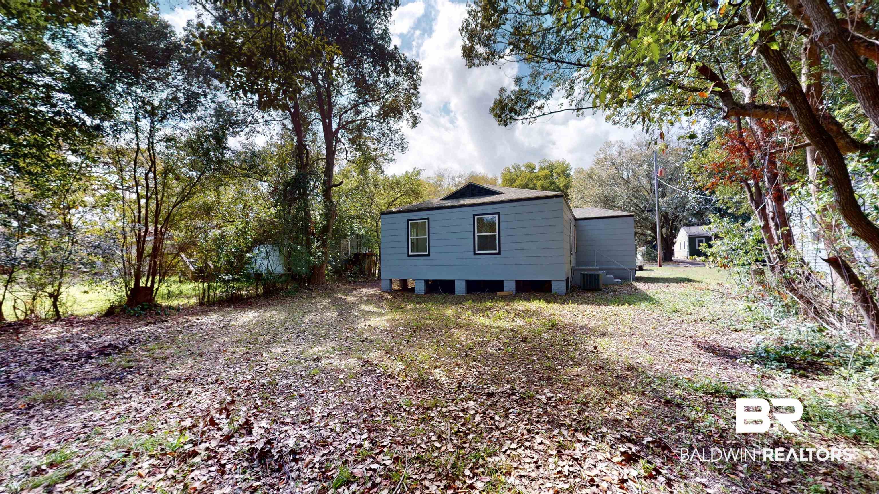 606 Shady Oak Drive Mobile, AL 36608 - Photo 13 of 14 Back of house with view of scattered trees