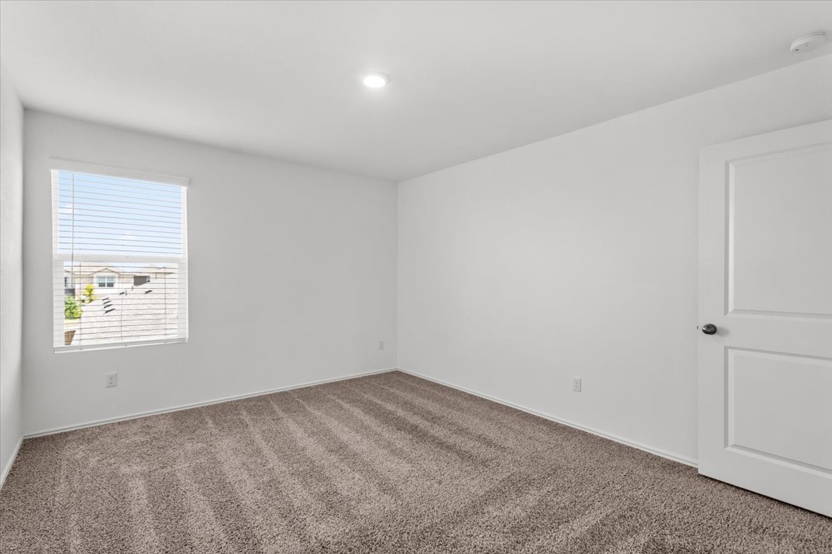 448 Perfect World Loop Jarrell, TX 76537 - Photo 40 of 40 A well-lit, neutral-toned room provides a versatile space, ready for personalization.