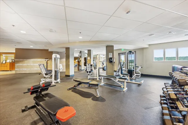 a room with gym equipment and view of living room