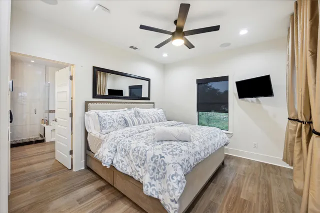a bedroom with a bed and a flat screen tv