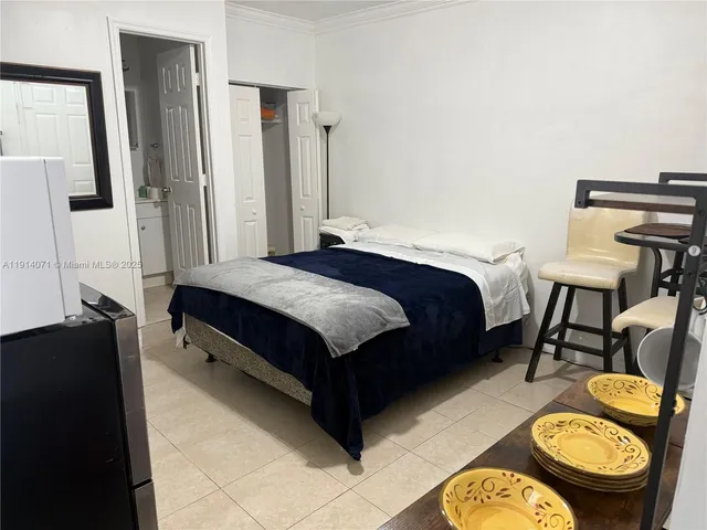 a spacious bedroom with a bed and dresser