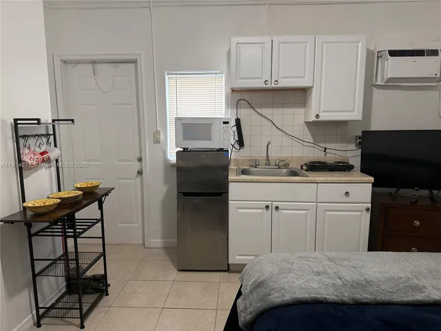 a bedroom with a bed and cabinets