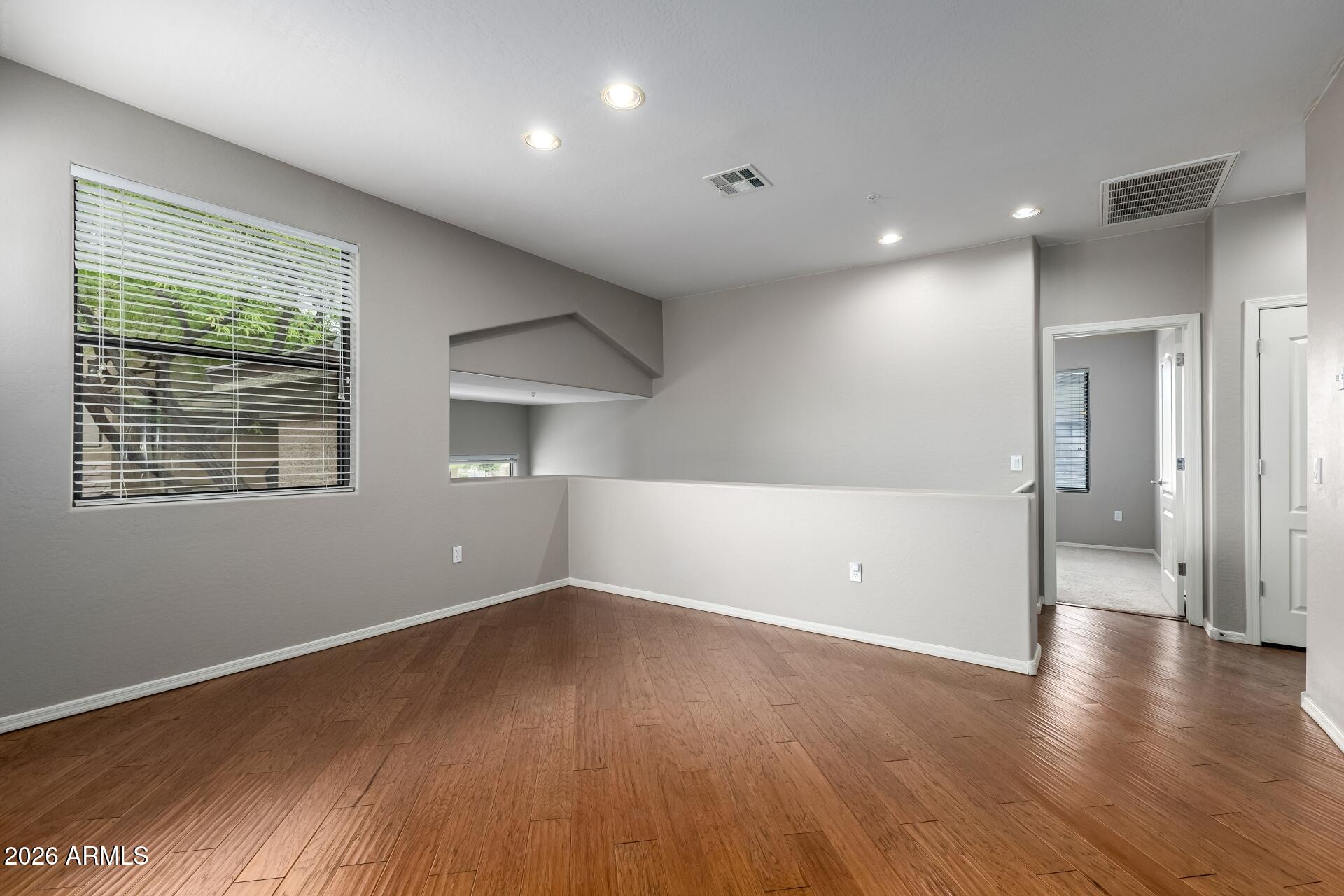 705 West Queen Creek Road, Unit 2114 Chandler, AZ 85248 - Photo 11 of 36 a view of empty room with wooden floor and fan