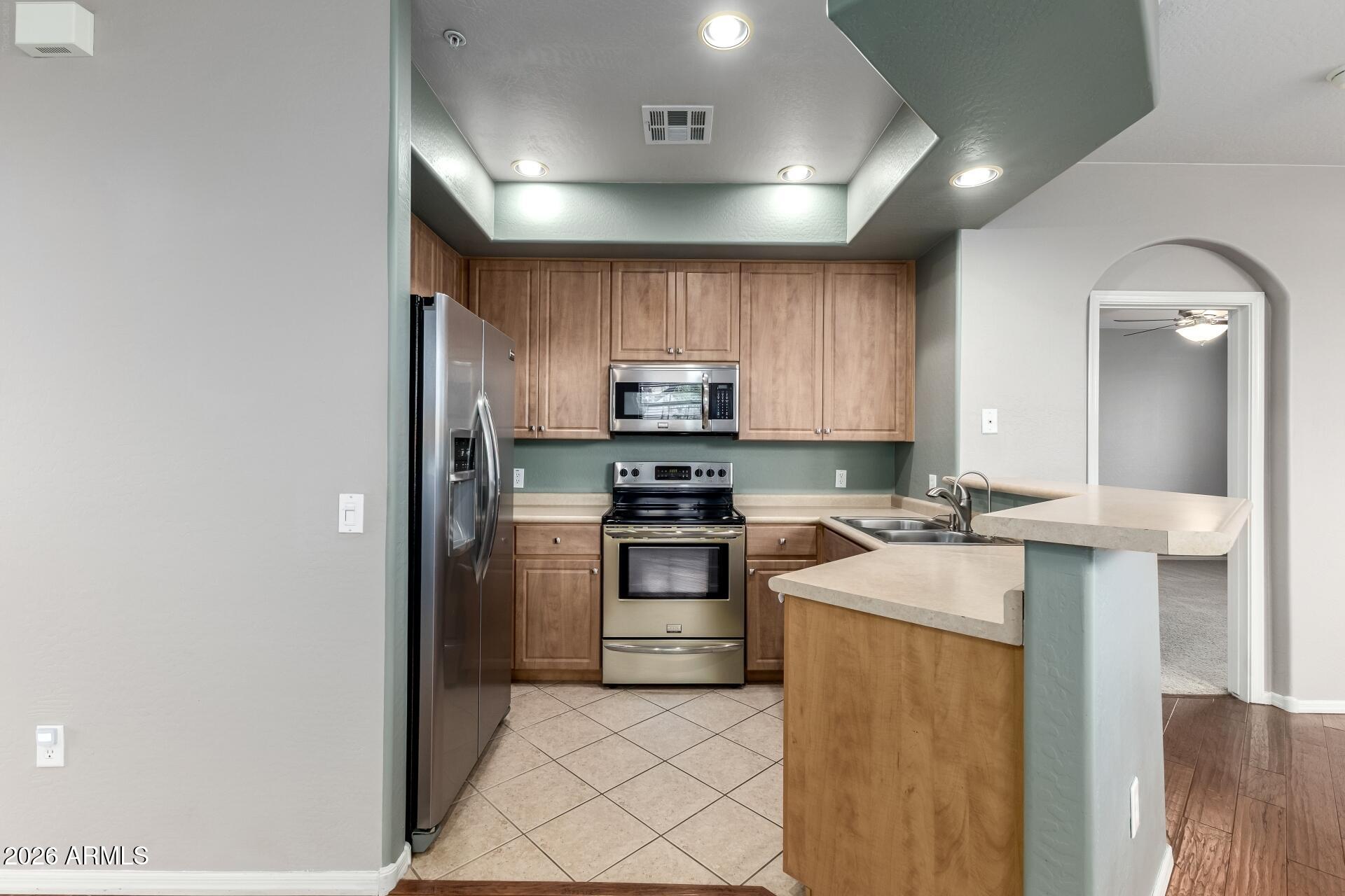705 West Queen Creek Road, Unit 2114 Chandler, AZ 85248 - Photo 15 of 36 a kitchen with a sink and stainless steel appliances