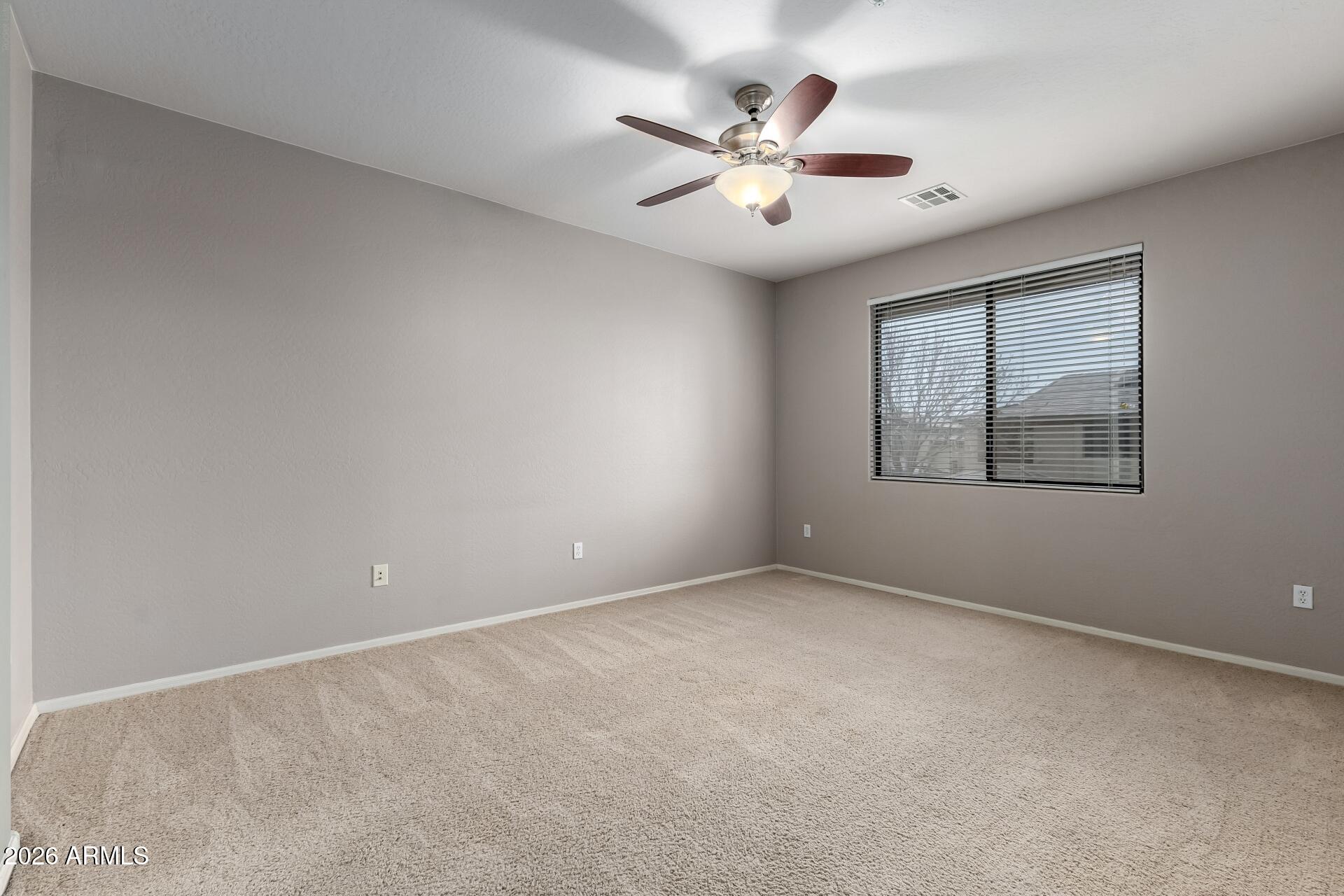 705 West Queen Creek Road, Unit 2114 Chandler, AZ 85248 - Photo 19 of 36 an empty room with windows and fan