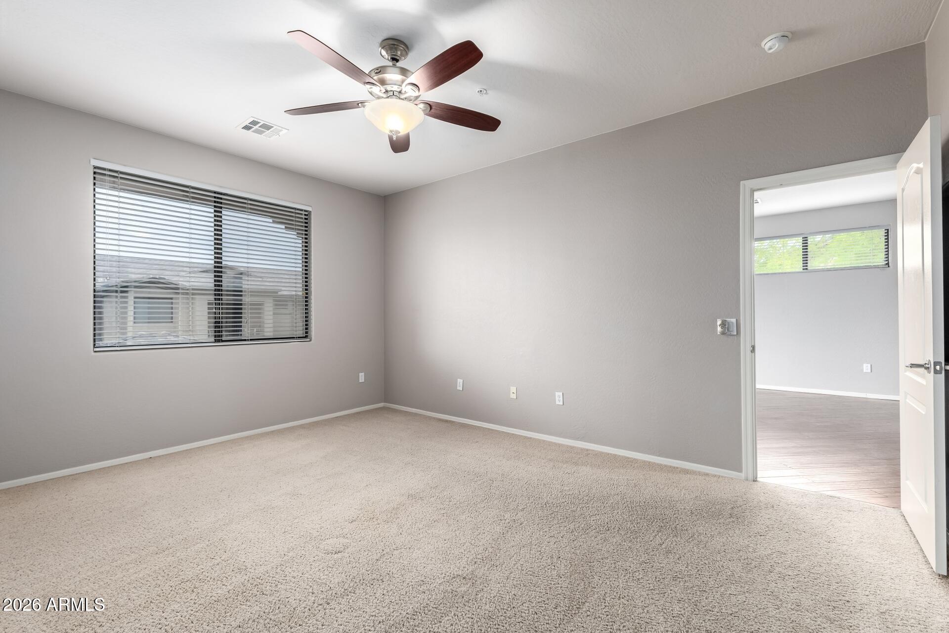 705 West Queen Creek Road, Unit 2114 Chandler, AZ 85248 - Photo 20 of 36 an empty room with windows and fan