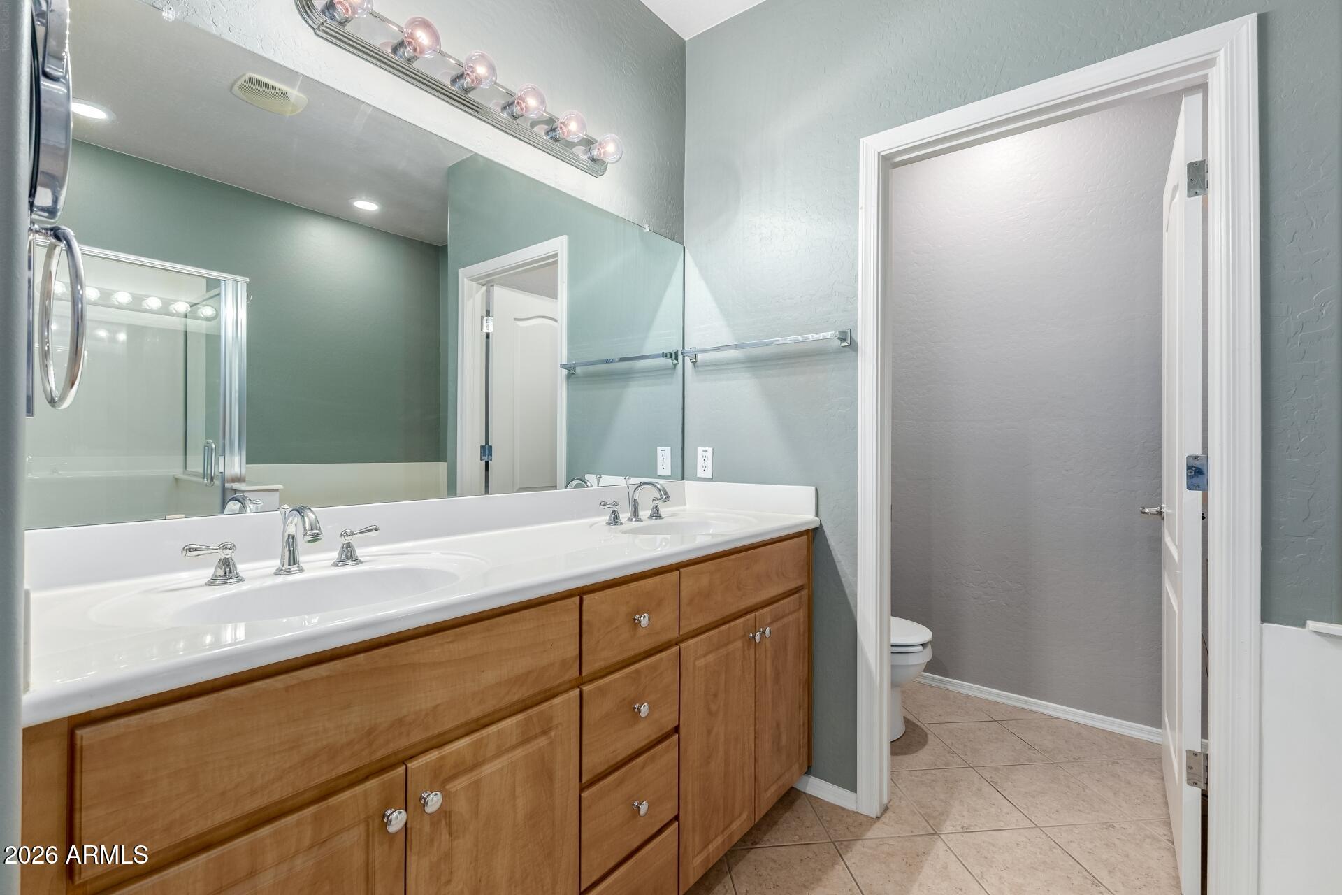 705 West Queen Creek Road, Unit 2114 Chandler, AZ 85248 - Photo 23 of 36 a bathroom with a double vanity sink and a mirror