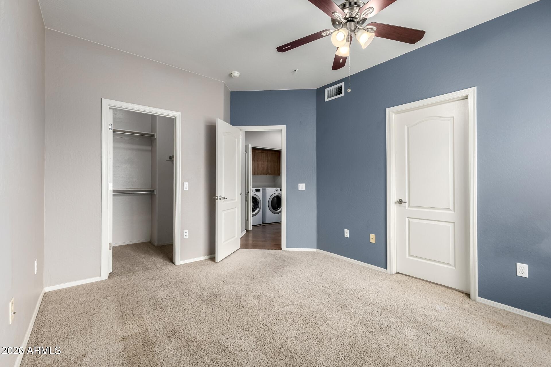 705 West Queen Creek Road, Unit 2114 Chandler, AZ 85248 - Photo 31 of 36 an empty room with fan and entryway