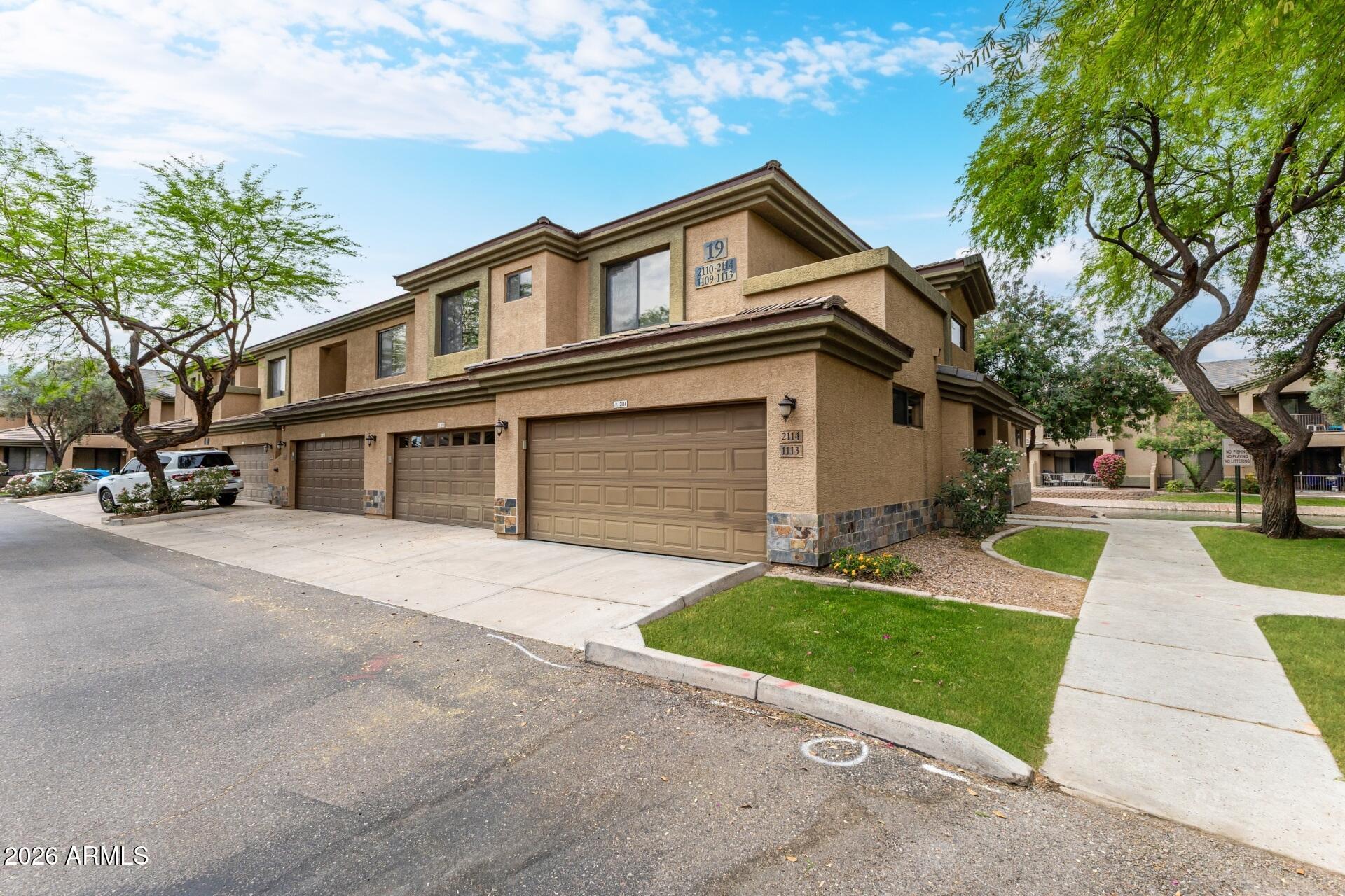 705 West Queen Creek Road, Unit 2114 Chandler, AZ 85248 - Photo 5 of 36 a front view of a house with a yard and trees