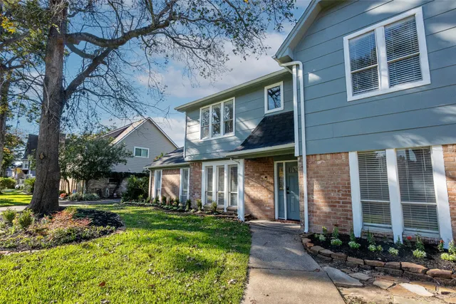a view of empty room with wooden floor and fireplace