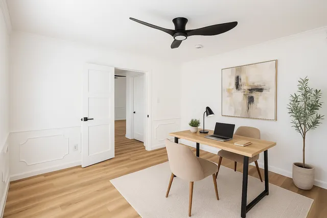 a dining room with furniture potted plants and wooden floor