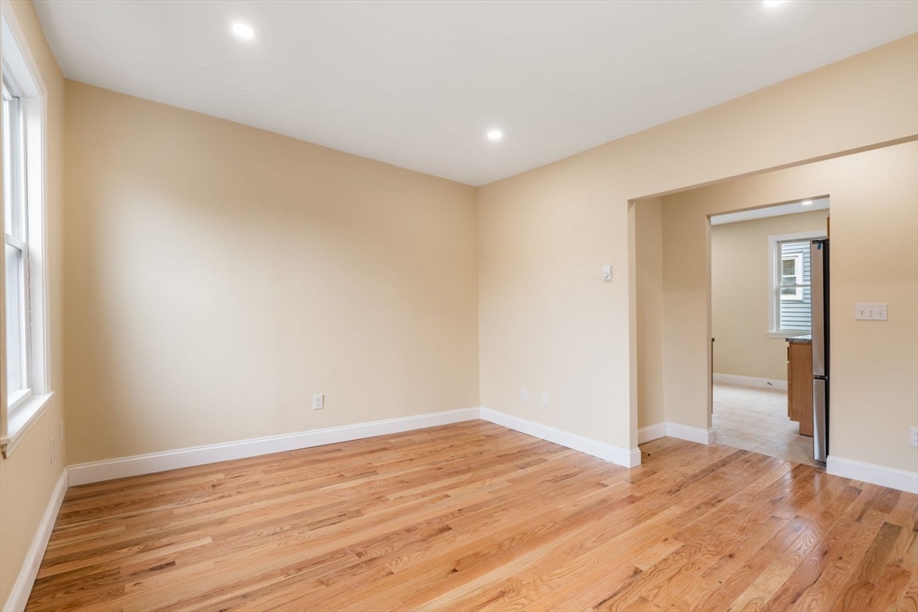 570 Washington Street, Unit 3 Boston, MA 02135 - Photo 3 of 11 a view of empty room with wooden floor and fan