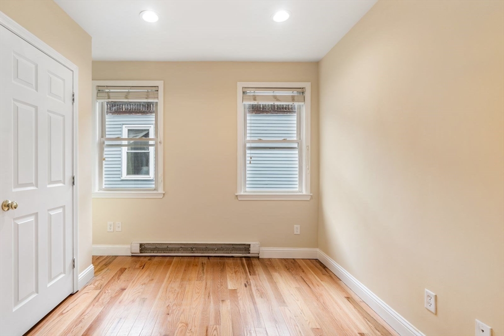570 Washington Street, Unit 3 Boston, MA 02135 - Photo 6 of 11 a view of empty room with wooden floor and fan