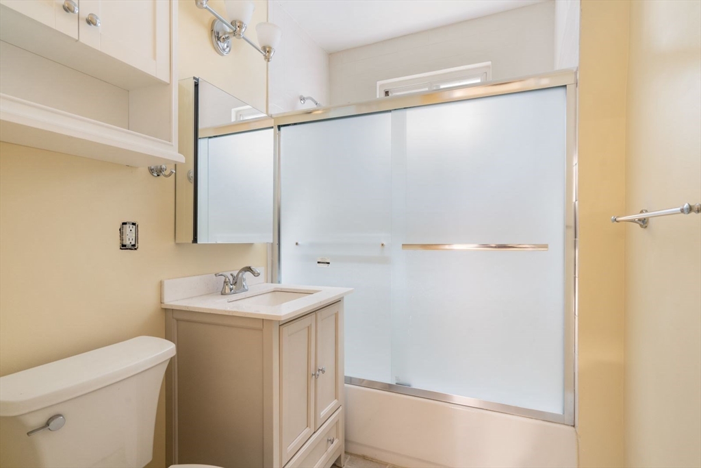 570 Washington Street, Unit 3 Boston, MA 02135 - Photo 7 of 11 a bathroom with a sink a toilet and shower