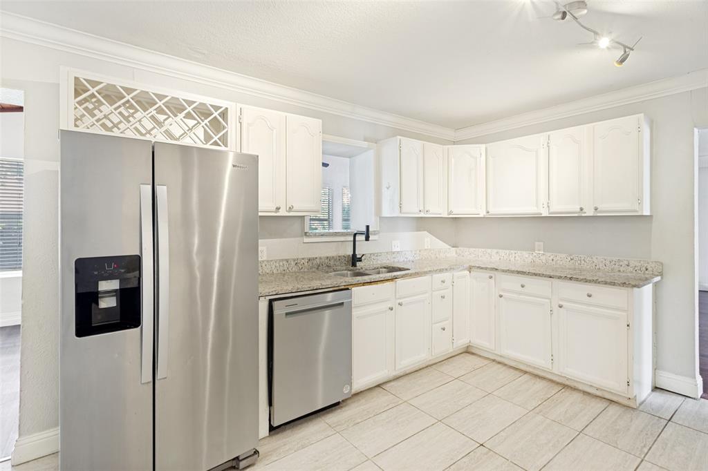 1904 Old Kirk Road Bedford, TX 76022 - Photo 12 of 25 a kitchen with stainless steel appliances granite countertop a refrigerator and a sink