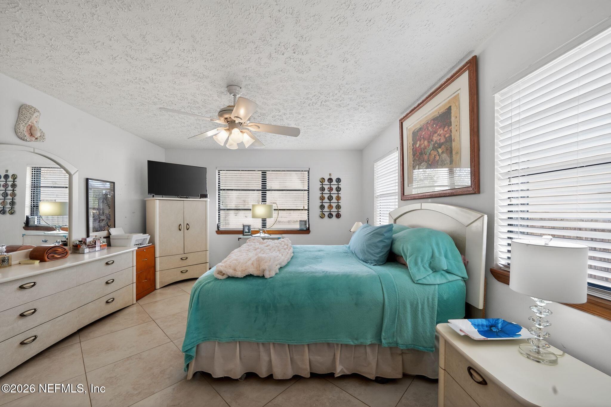 4543 Southeast Dryfus Avenue Stuart, FL 34997 - Photo 20 of 46 a bedroom with a bed and a window