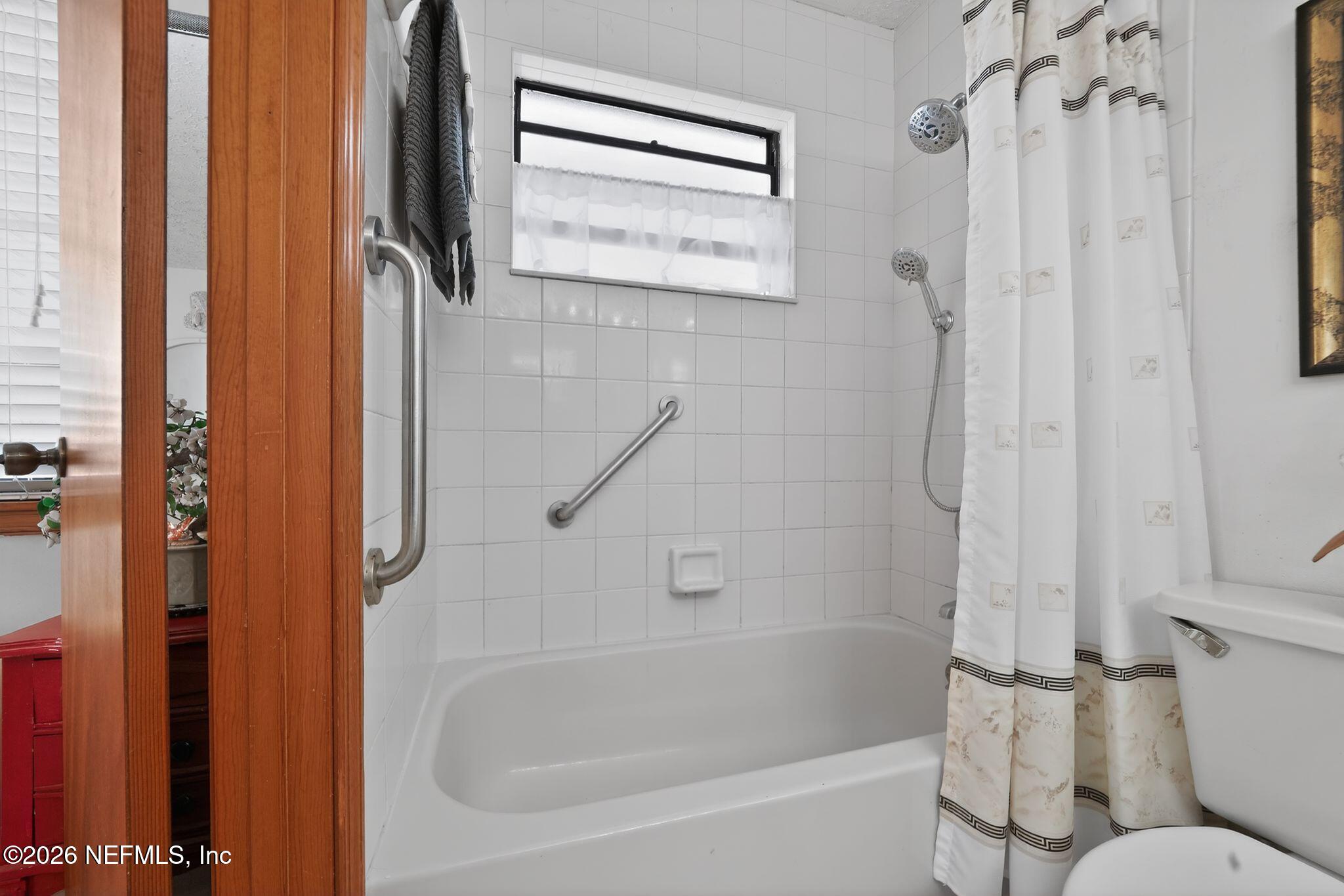 4543 Southeast Dryfus Avenue Stuart, FL 34997 - Photo 25 of 46 a bathroom with a bathtub and a shower