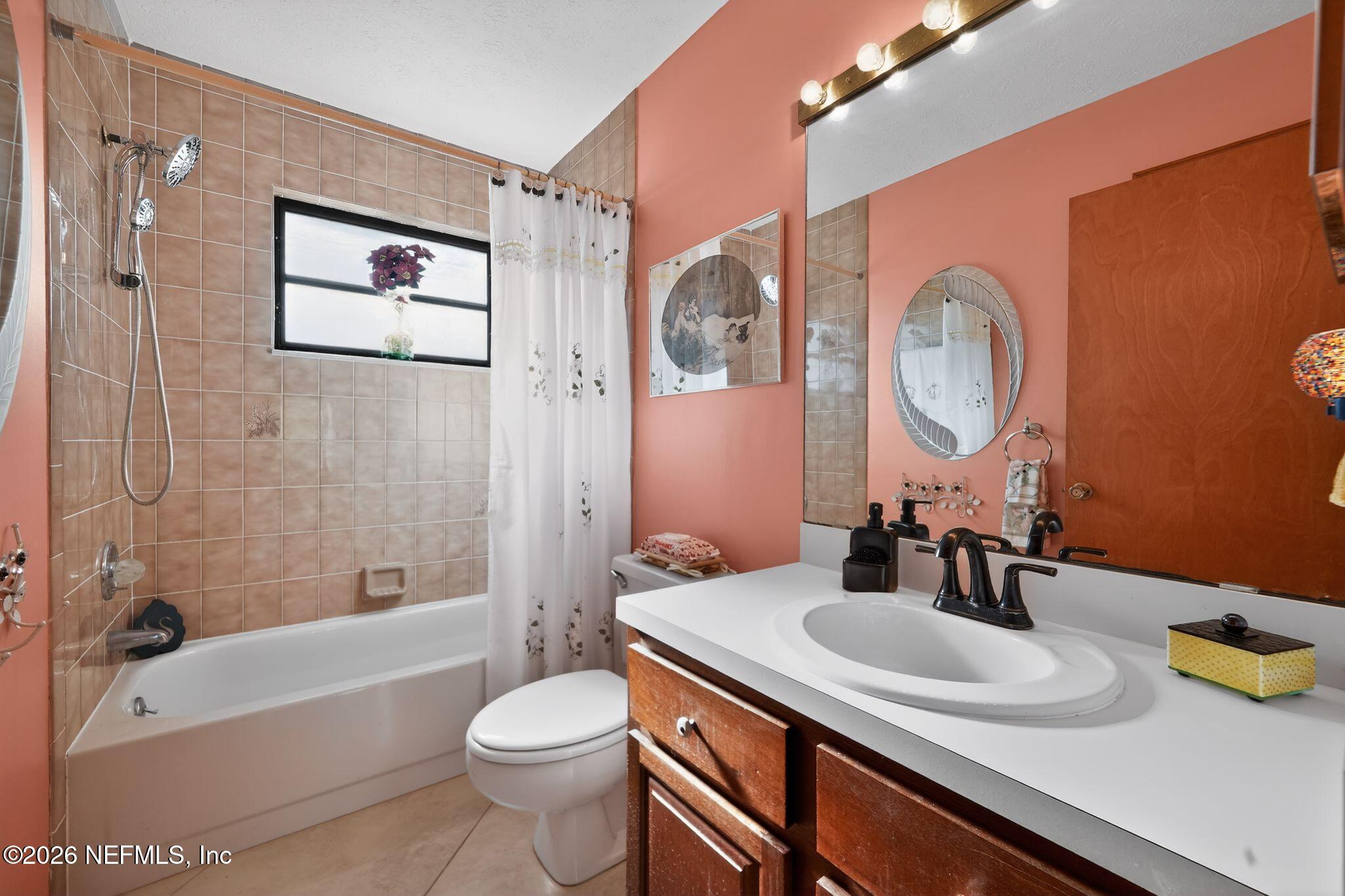 4543 Southeast Dryfus Avenue Stuart, FL 34997 - Photo 26 of 46 a bathroom with a sink a toilet and shower