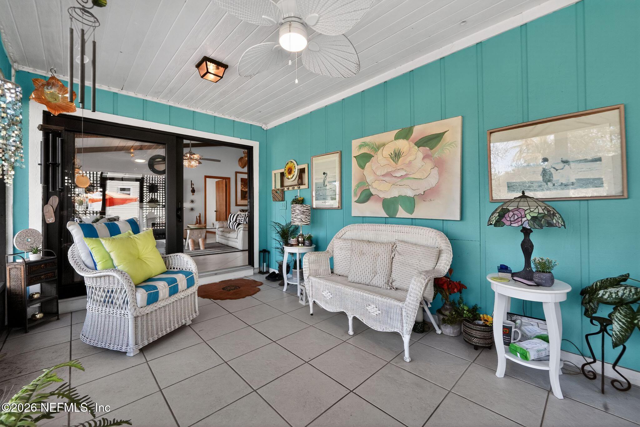 4543 Southeast Dryfus Avenue Stuart, FL 34997 - Photo 27 of 46 a living room with furniture and a painting on the wall