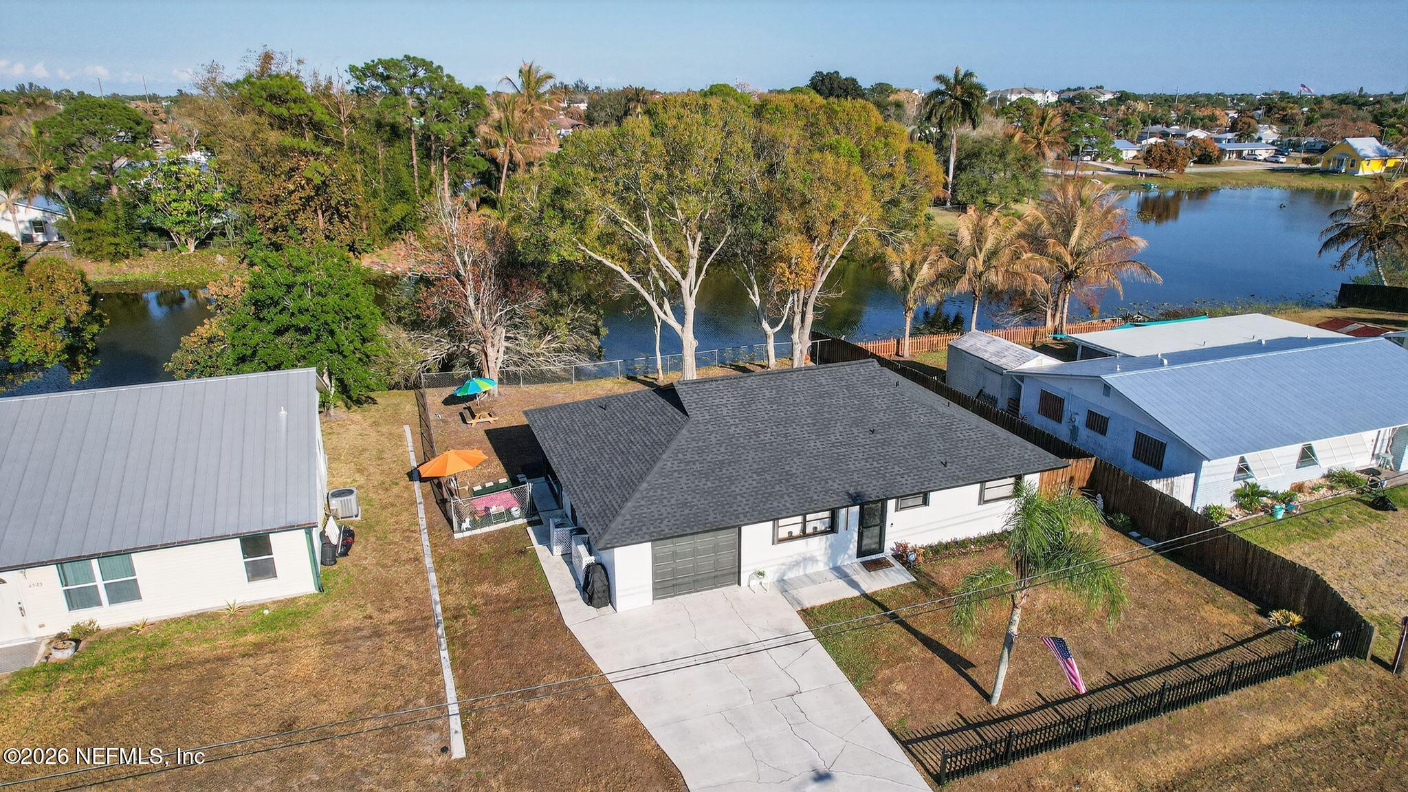 4543 Southeast Dryfus Avenue Stuart, FL 34997 - Photo 41 of 46 an aerial view of a house with swimming pool and sitting space