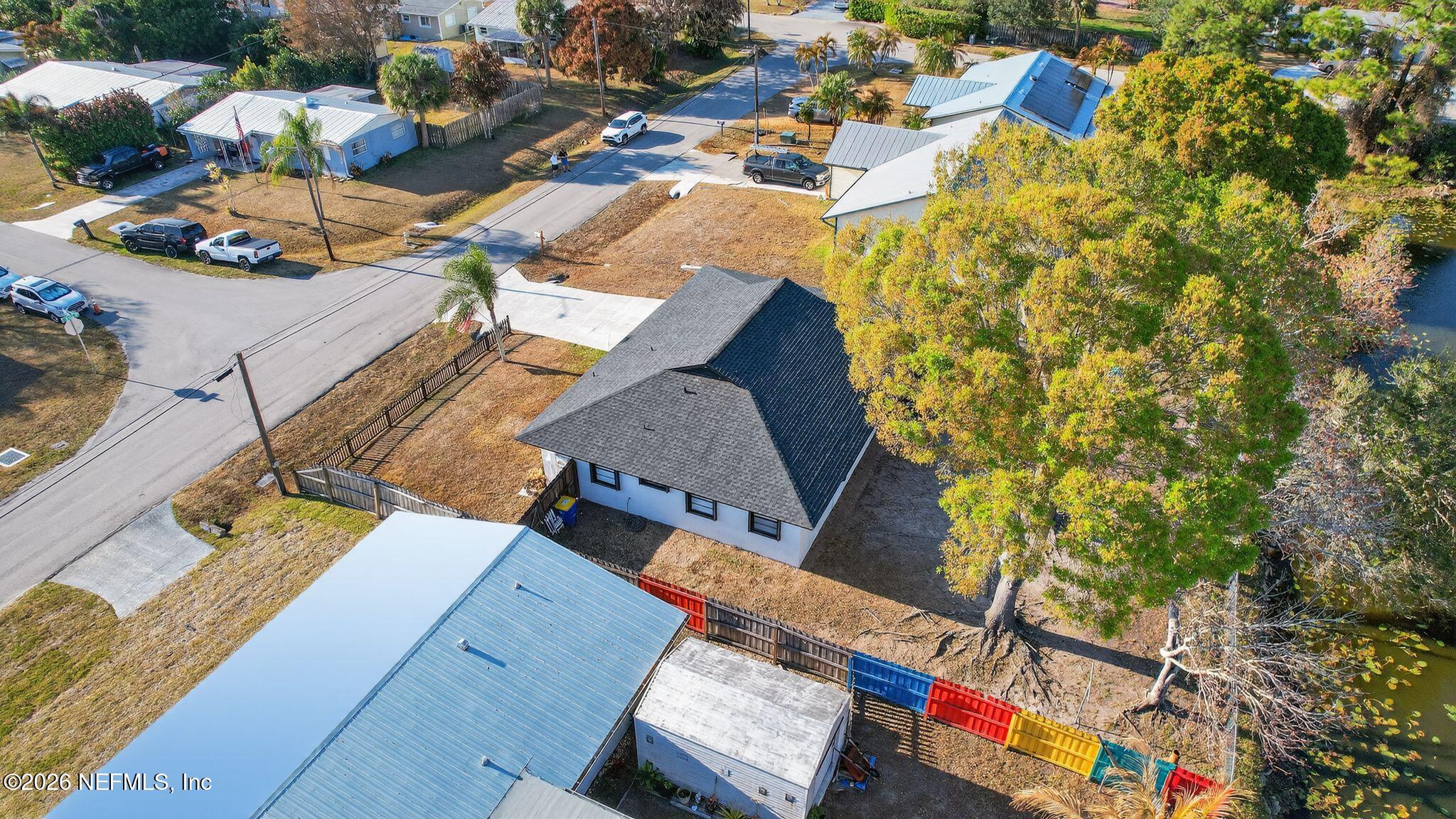 4543 Southeast Dryfus Avenue Stuart, FL 34997 - Photo 43 of 46 an aerial view of a house with a yard and lake view