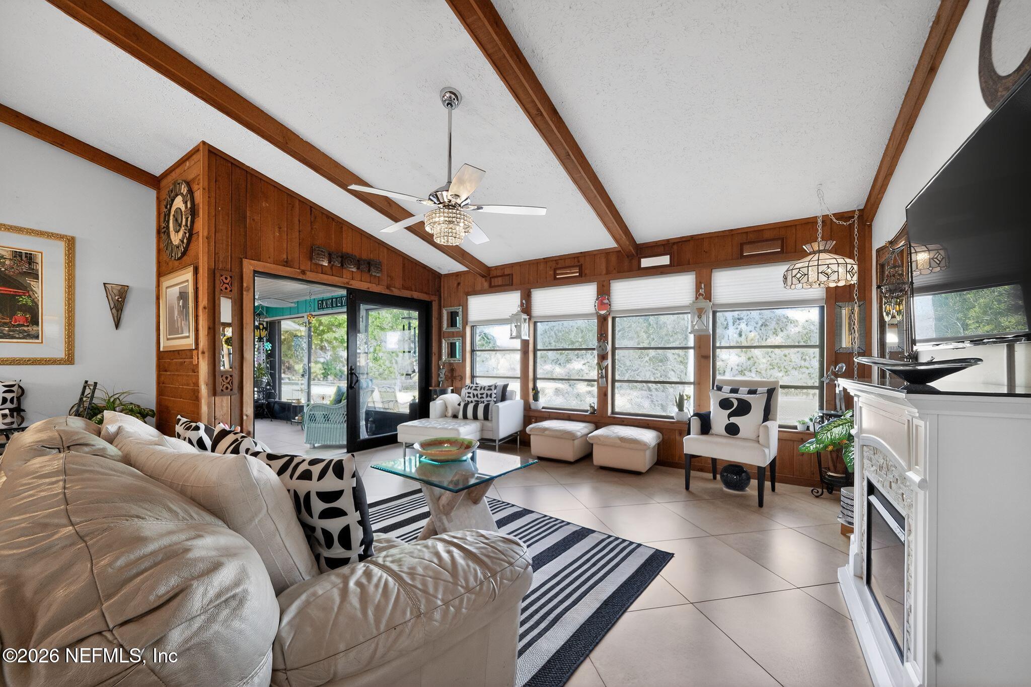 4543 Southeast Dryfus Avenue Stuart, FL 34997 - Photo 7 of 46 a living room with furniture and a large window