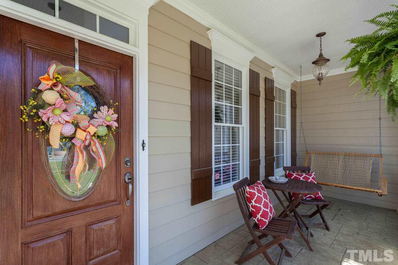 5216 Levering Mill Road Apex, NC 27539 - Photo 2 of 23 a view of a porch with a table and chairs