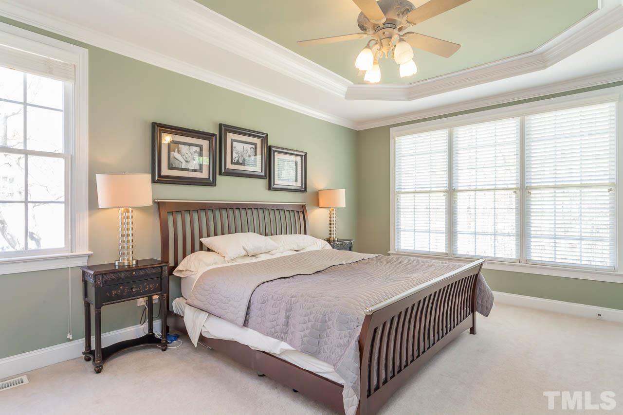5216 Levering Mill Road Apex, NC 27539 - Photo 14 of 23 a bedroom with a bed and a window