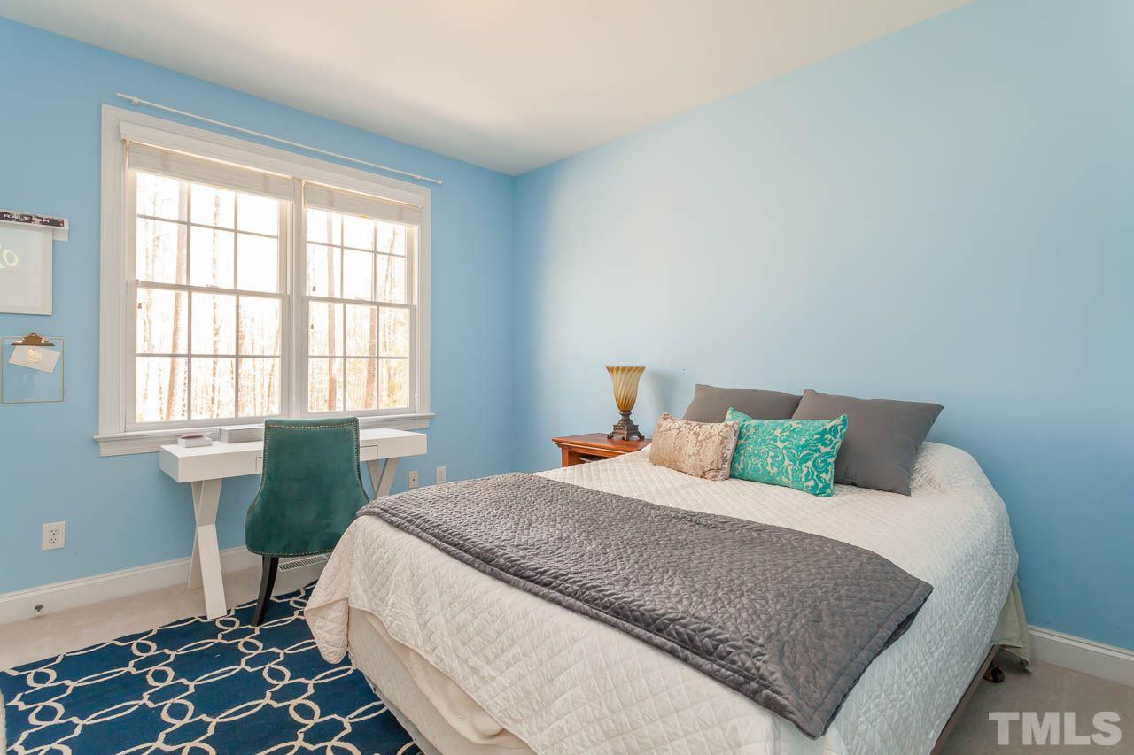 5216 Levering Mill Road Apex, NC 27539 - Photo 16 of 23 a bedroom with a bed and a window