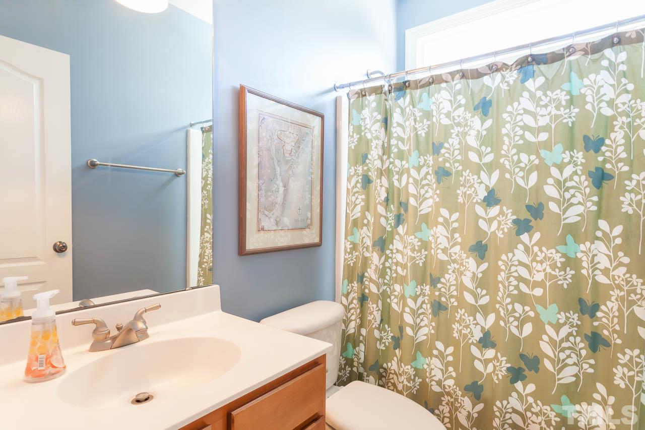 5216 Levering Mill Road Apex, NC 27539 - Photo 17 of 23 a bathroom with a sink and a mirror
