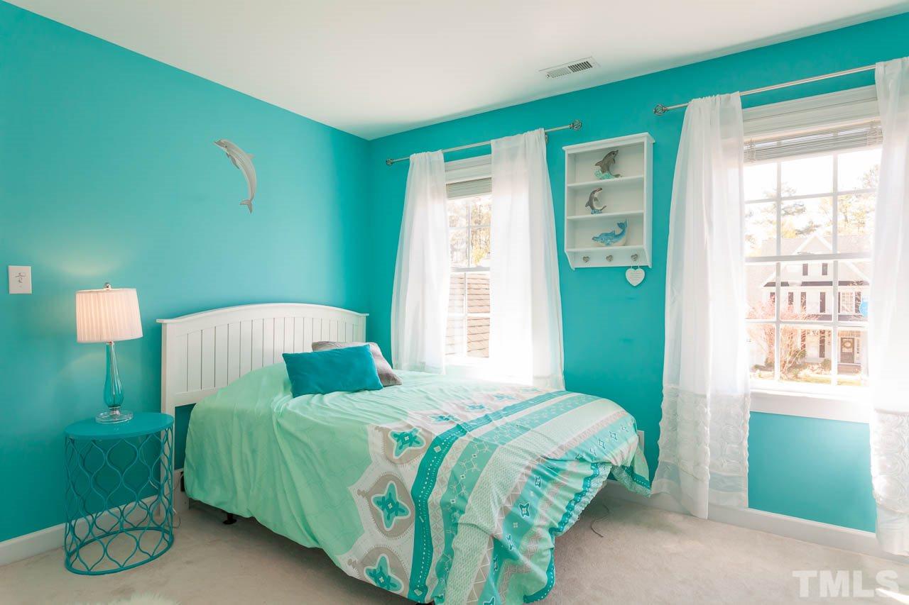 5216 Levering Mill Road Apex, NC 27539 - Photo 18 of 23 a bedroom with a bed and a window
