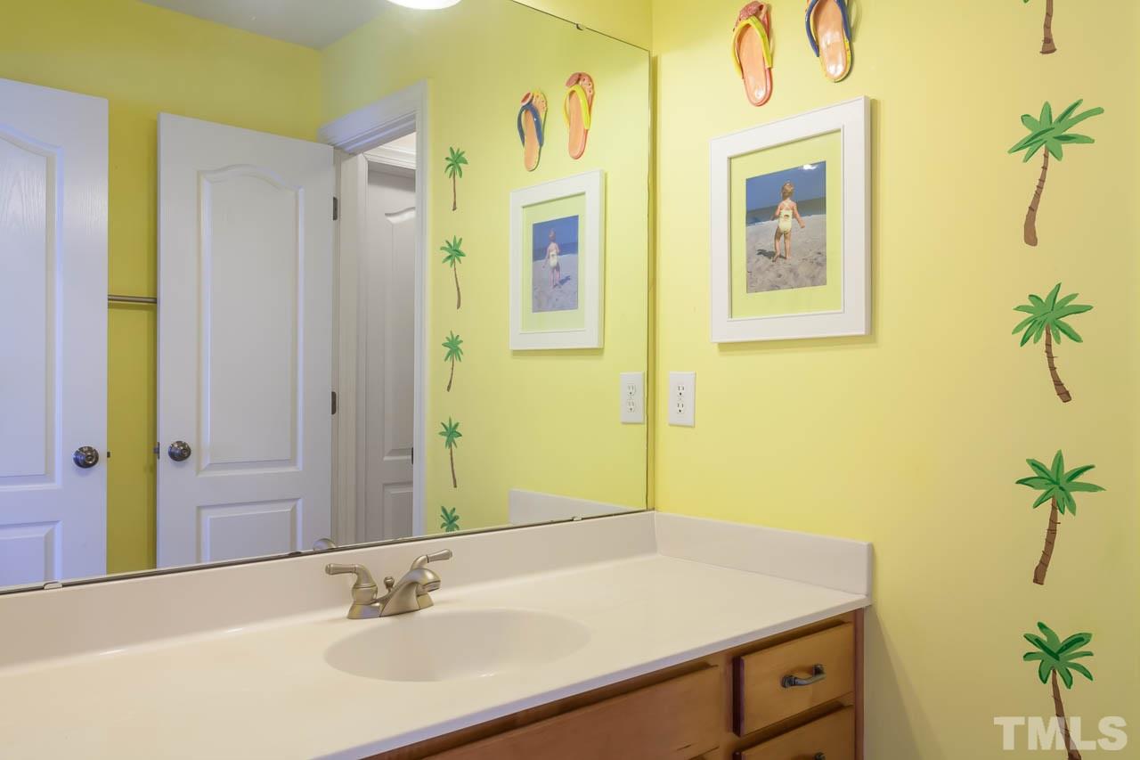 5216 Levering Mill Road Apex, NC 27539 - Photo 19 of 23 a bathroom with a sink and a mirror