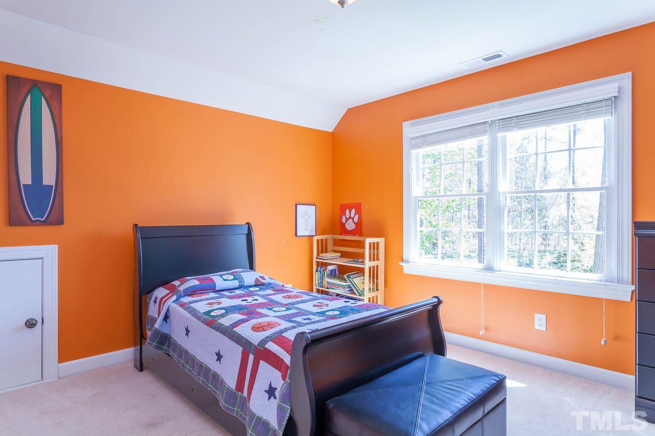 5216 Levering Mill Road Apex, NC 27539 - Photo 20 of 23 a bedroom with a bed and window