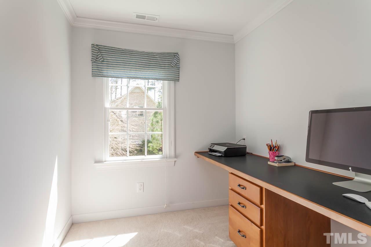 5216 Levering Mill Road Apex, NC 27539 - Photo 21 of 23 a room with a desk and a window