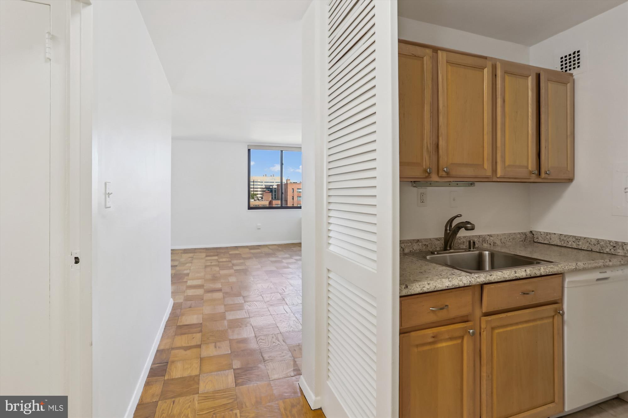 2030 F Street Northwest, Unit 906 Washington, DC 20006 - Photo 11 of 33 a kitchen with a sink and cabinets