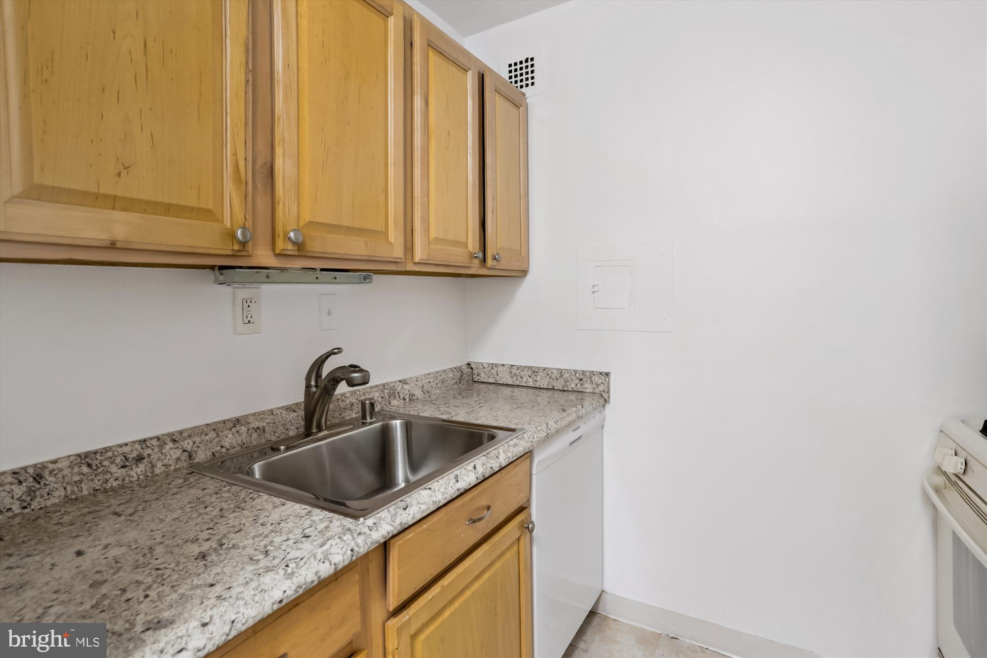 2030 F Street Northwest, Unit 906 Washington, DC 20006 - Photo 22 of 33 a kitchen with a sink and cabinets