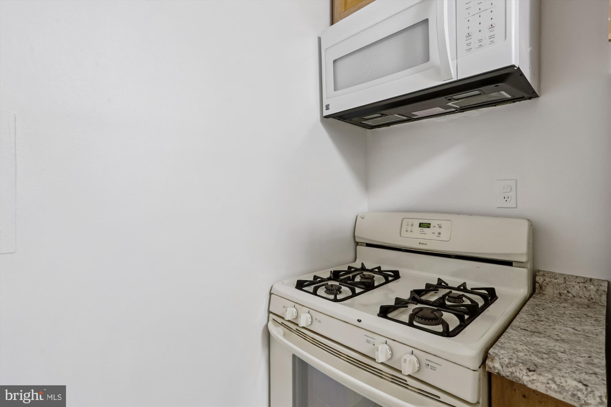 2030 F Street Northwest, Unit 906 Washington, DC 20006 - Photo 23 of 33 a white stove top oven sitting inside of a kitchen