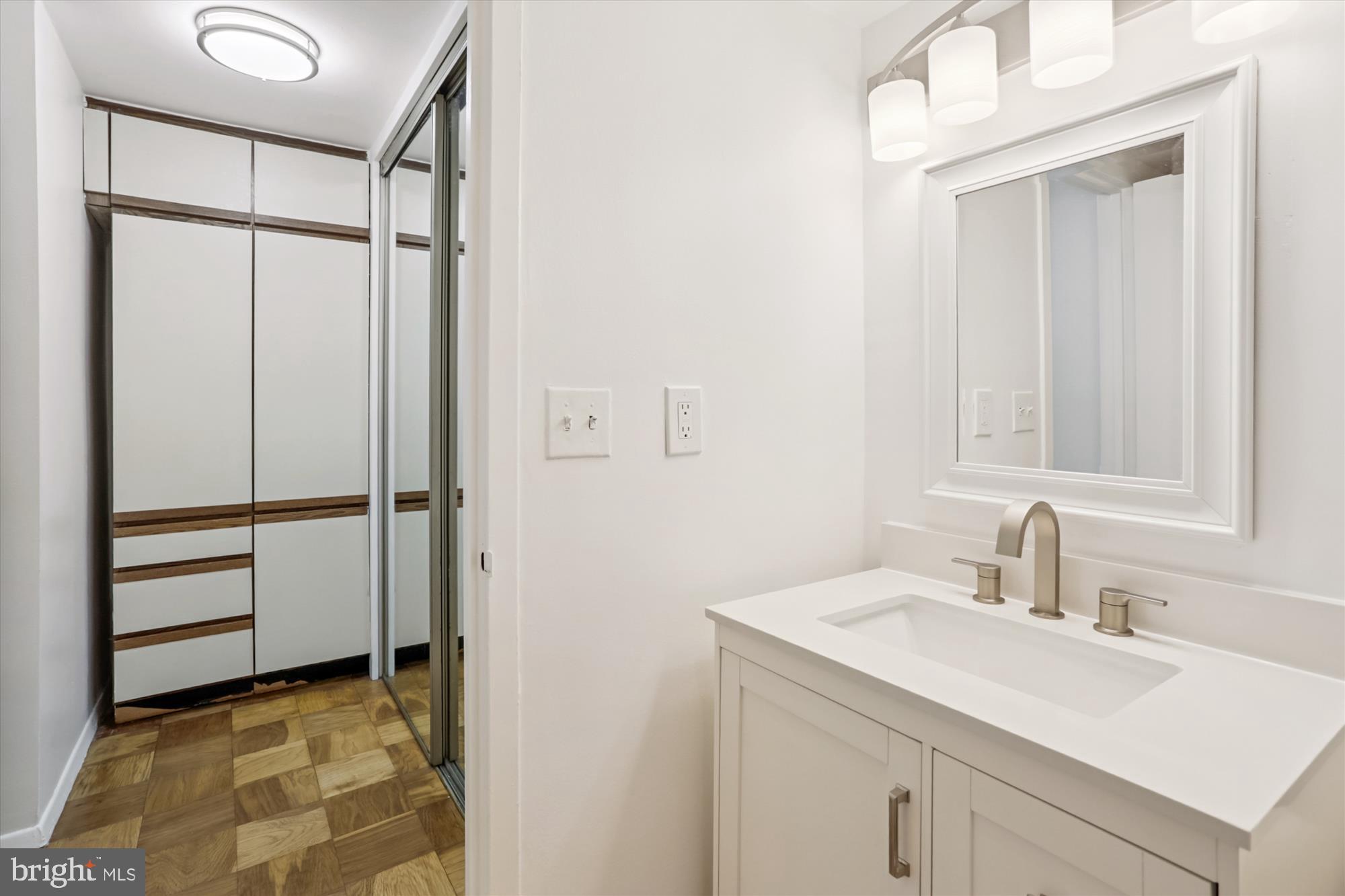 2030 F Street Northwest, Unit 906 Washington, DC 20006 - Photo 28 of 33 a bathroom with a sink and a mirror