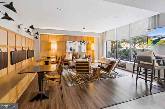 an entryway with sitting space and wooden floor