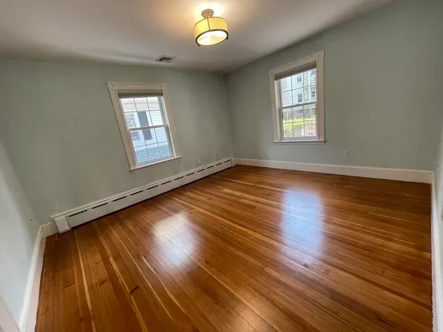 a view of room with window and wooden floor