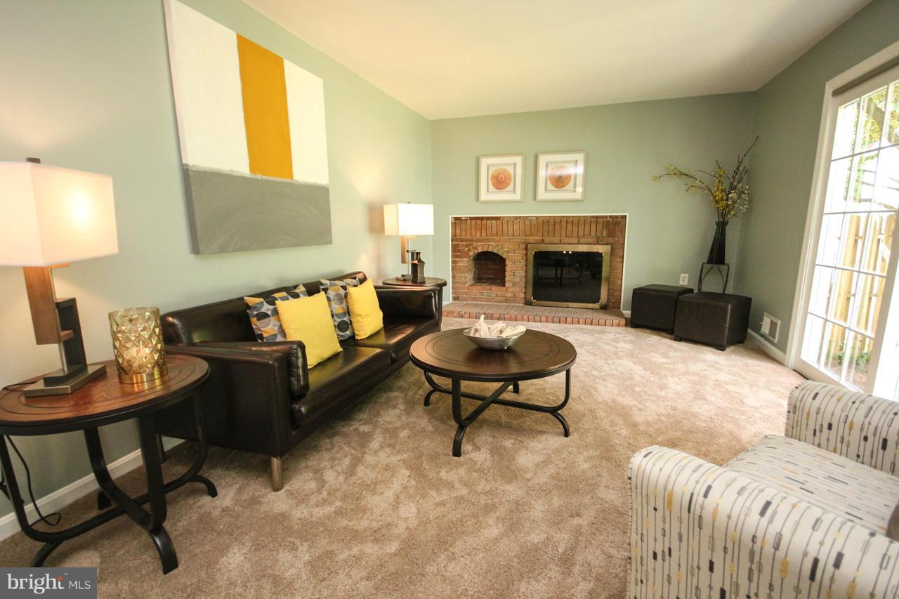 1429 Winding Waye Lane Silver Spring, MD 20902 - Photo 13 of 30 a living room with furniture and a fireplace