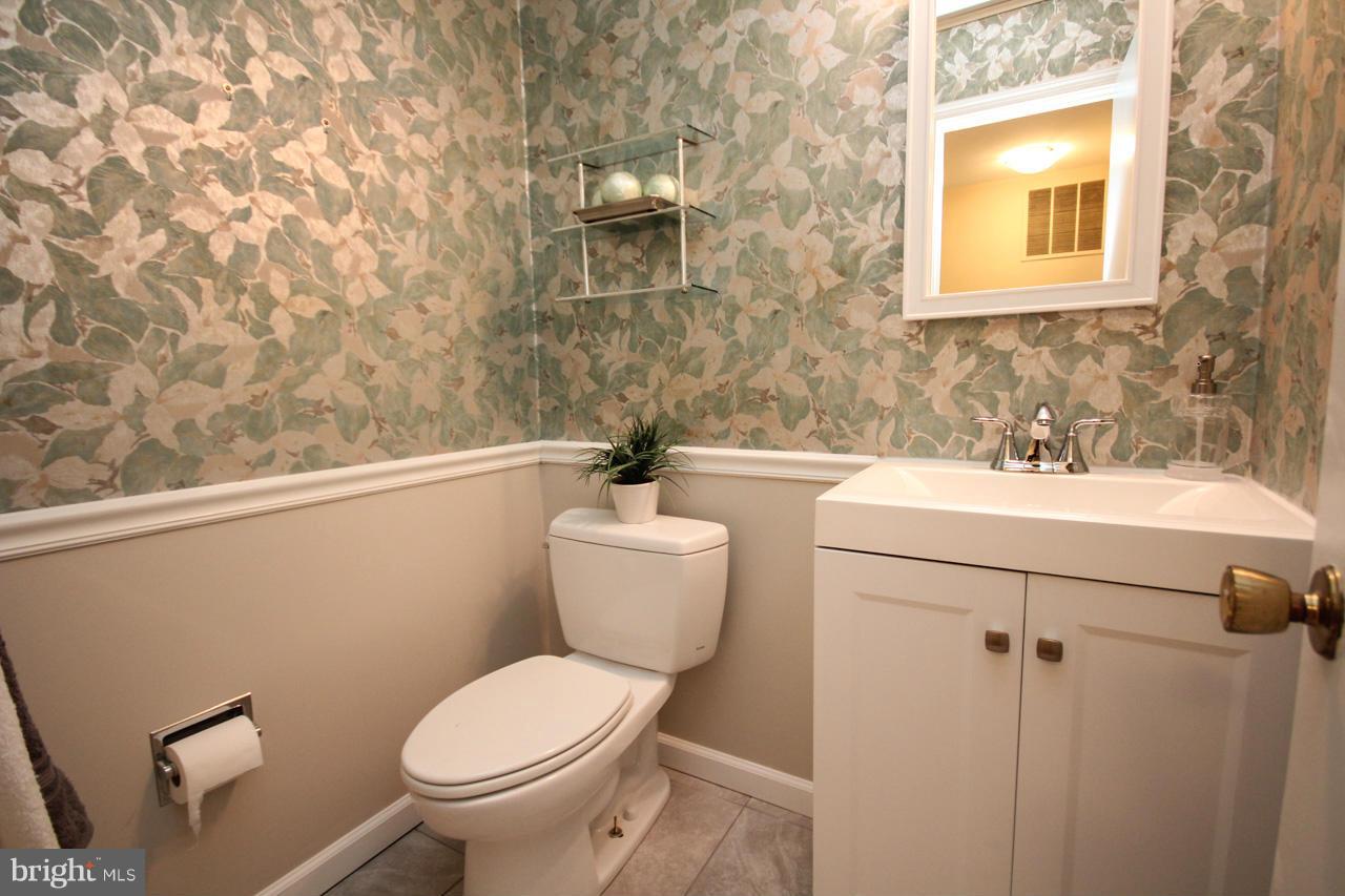 1429 Winding Waye Lane Silver Spring, MD 20902 - Photo 16 of 30 a bathroom with a sink mirror vanity and toilet