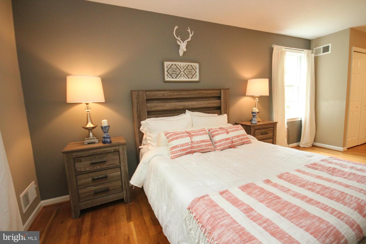 1429 Winding Waye Lane Silver Spring, MD 20902 - Photo 17 of 30 a bedroom with a bed and wooden floor