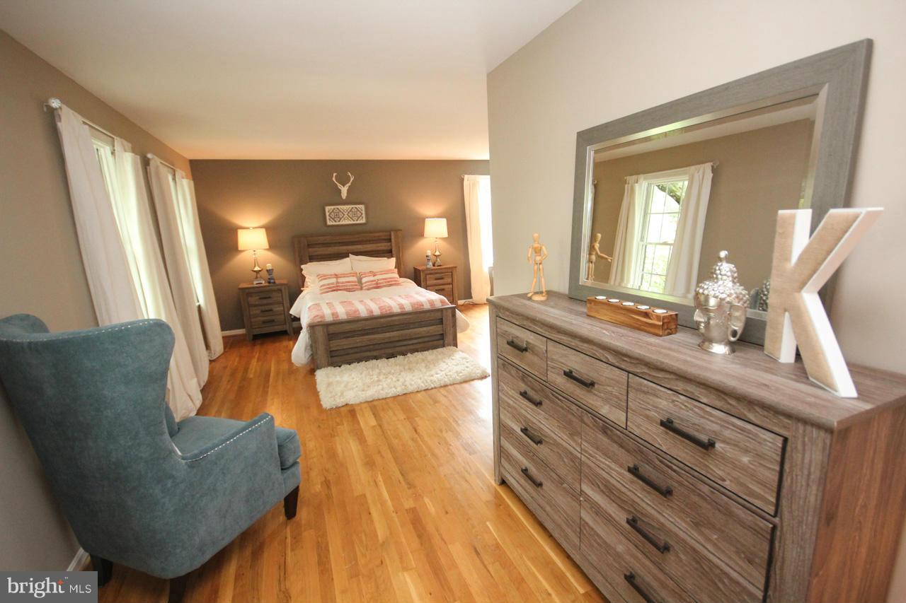 1429 Winding Waye Lane Silver Spring, MD 20902 - Photo 19 of 30 a bedroom with furniture and wooden floor