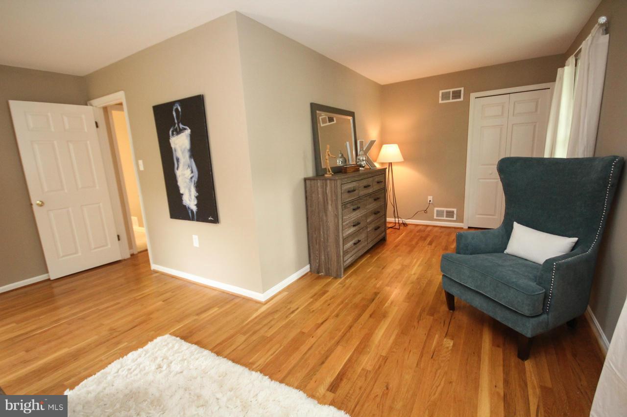 1429 Winding Waye Lane Silver Spring, MD 20902 - Photo 20 of 30 a living room with furniture and a flat screen tv